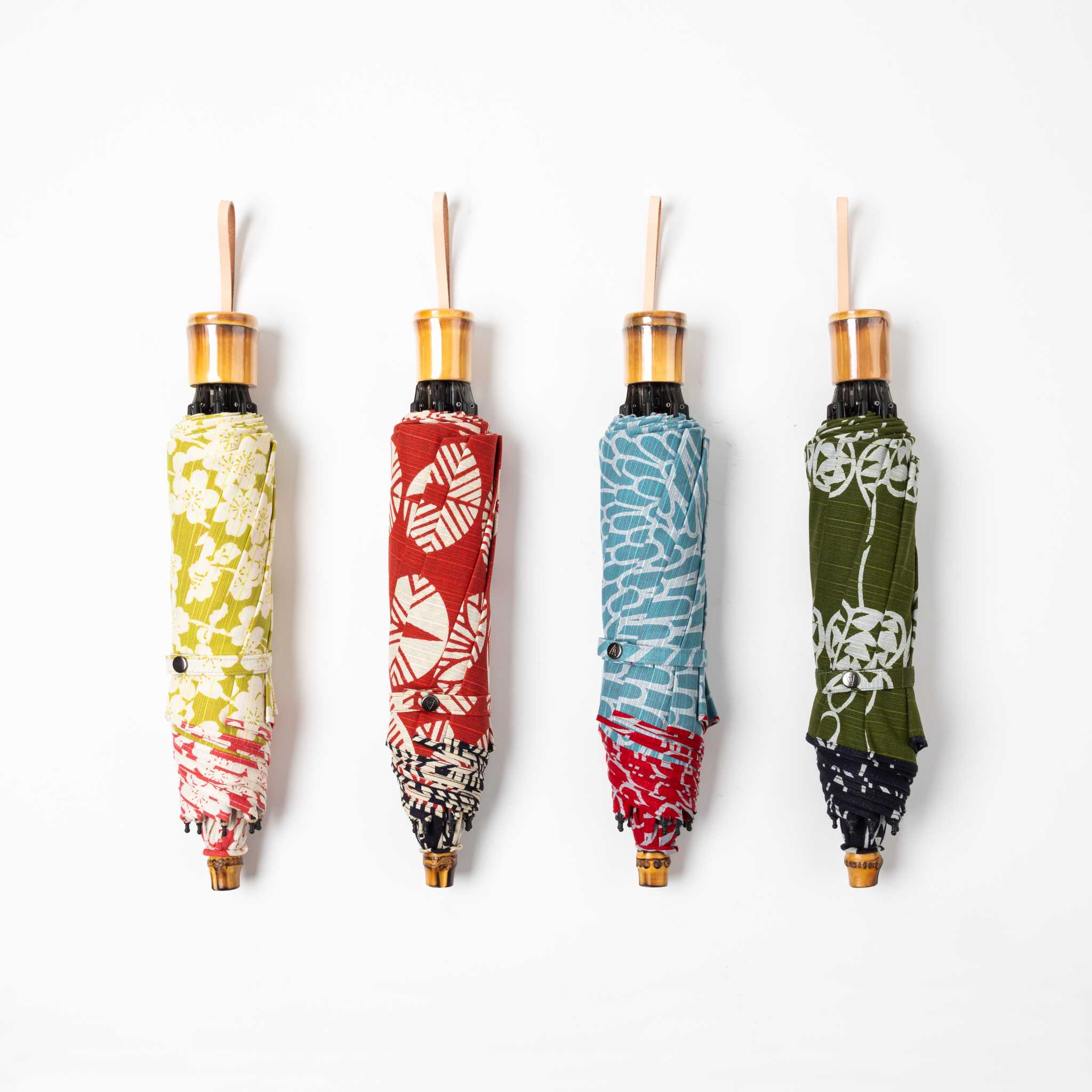 four colorful folding umbrellas