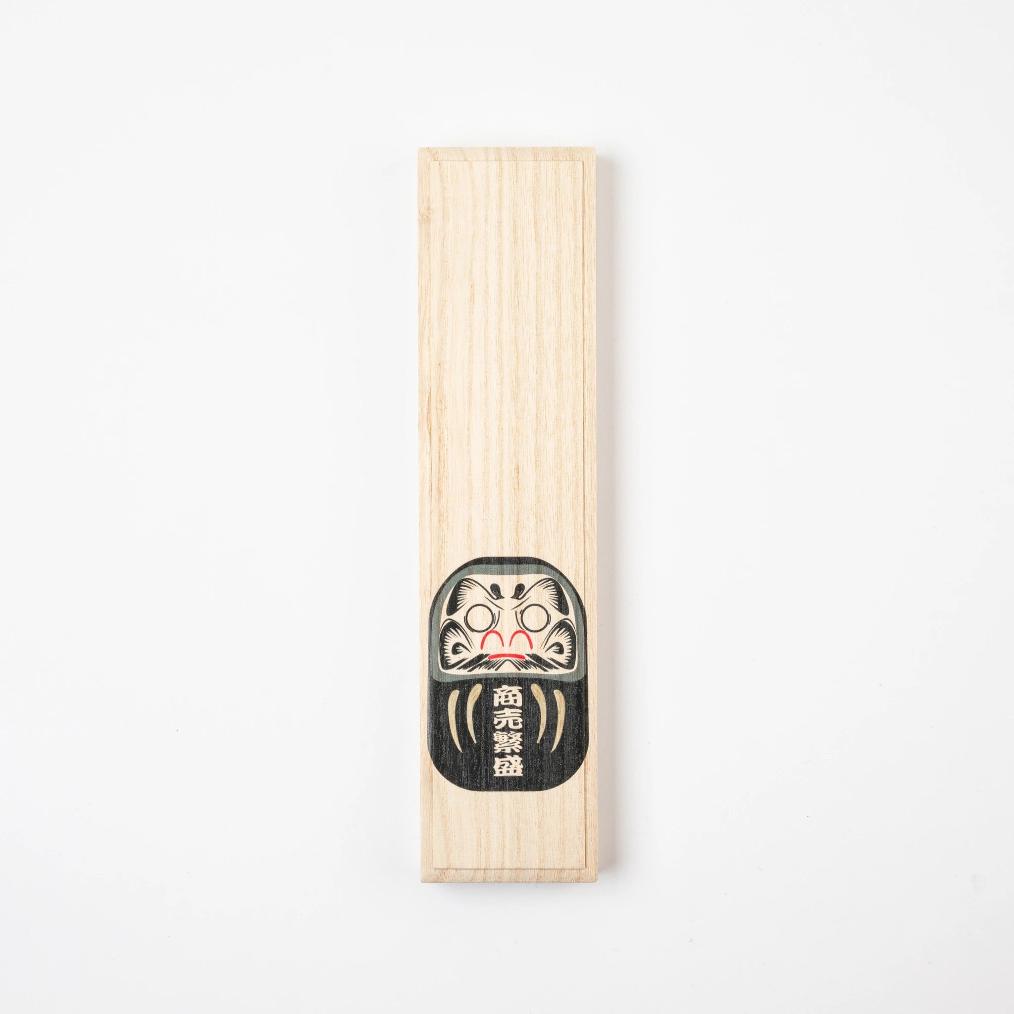 Closed paulownia gift box with a black Daruma illustration for Hyozaemon lacquer chopsticks.