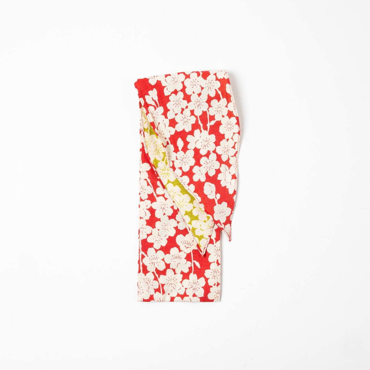 A folded Isa Moyō Folding Umbrella pouch displaying the Sakura (Cherry Blossom) motif in pink with a contrasting light green inner lining.