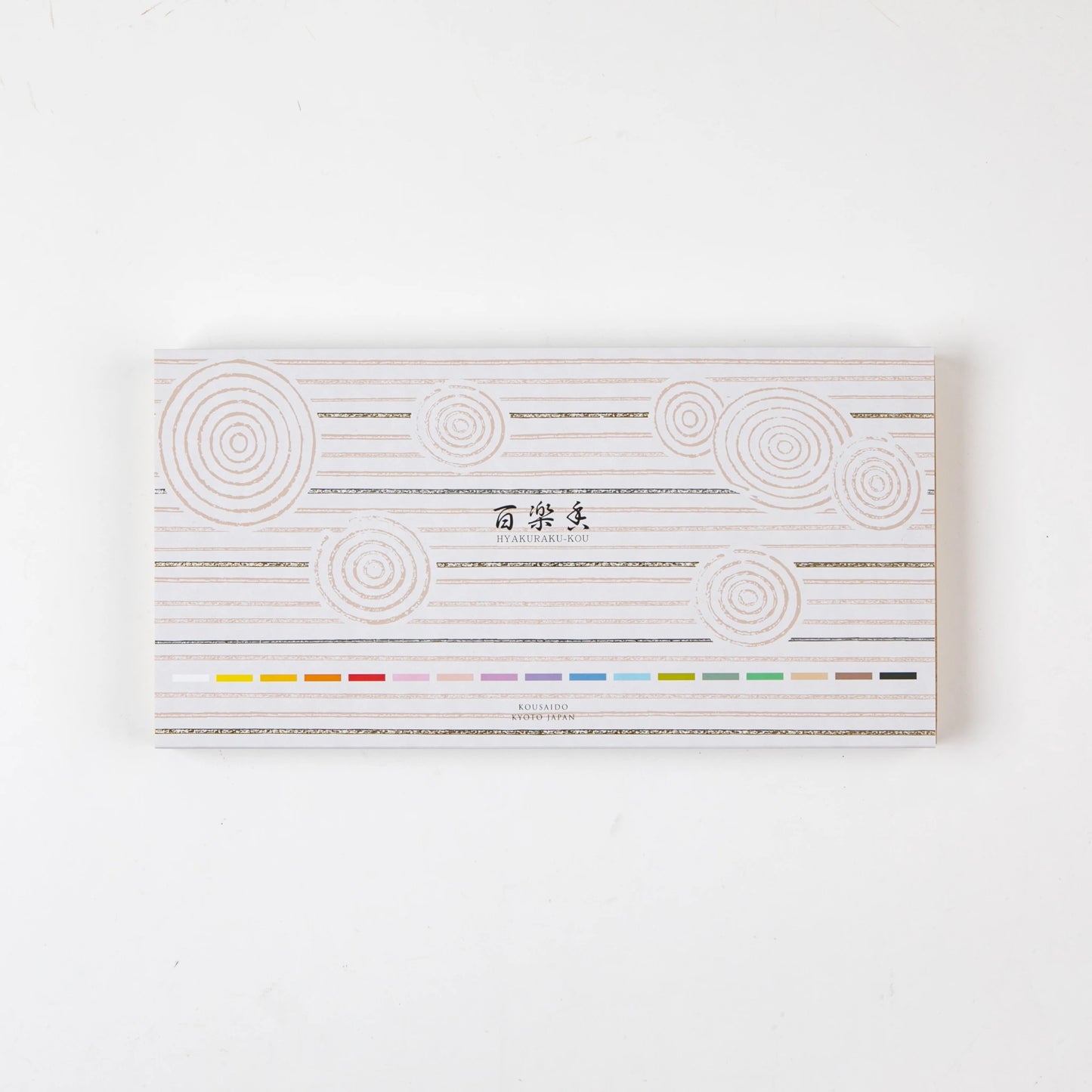 Closed box of Kosaido Hyakuraku-kou incense, decorated with circular line motifs and scent color indicators.