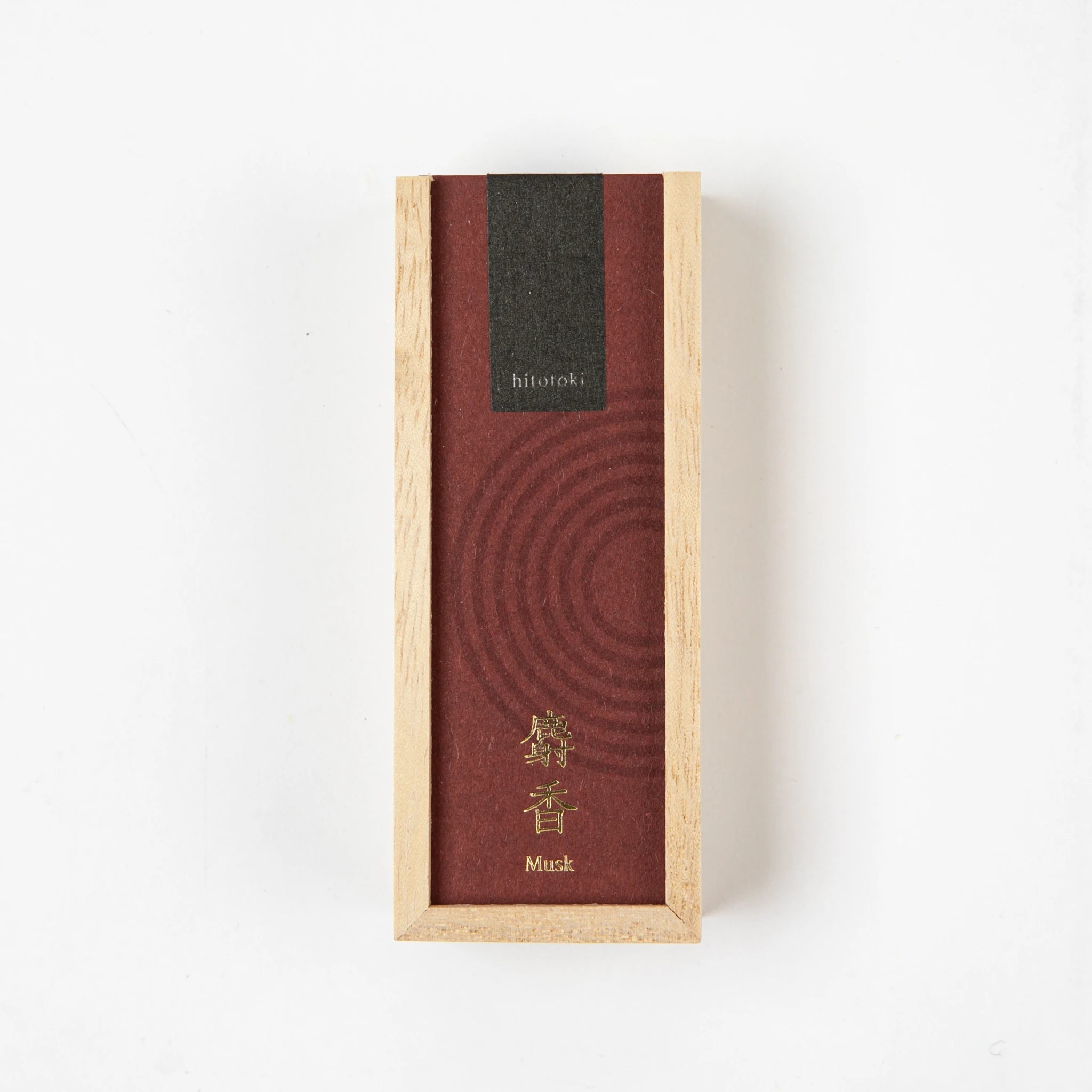 A rectangular wooden box with a deep red label and gold kanji, containing Kosaido hitotoki incense in musk scent, placed on a white background.