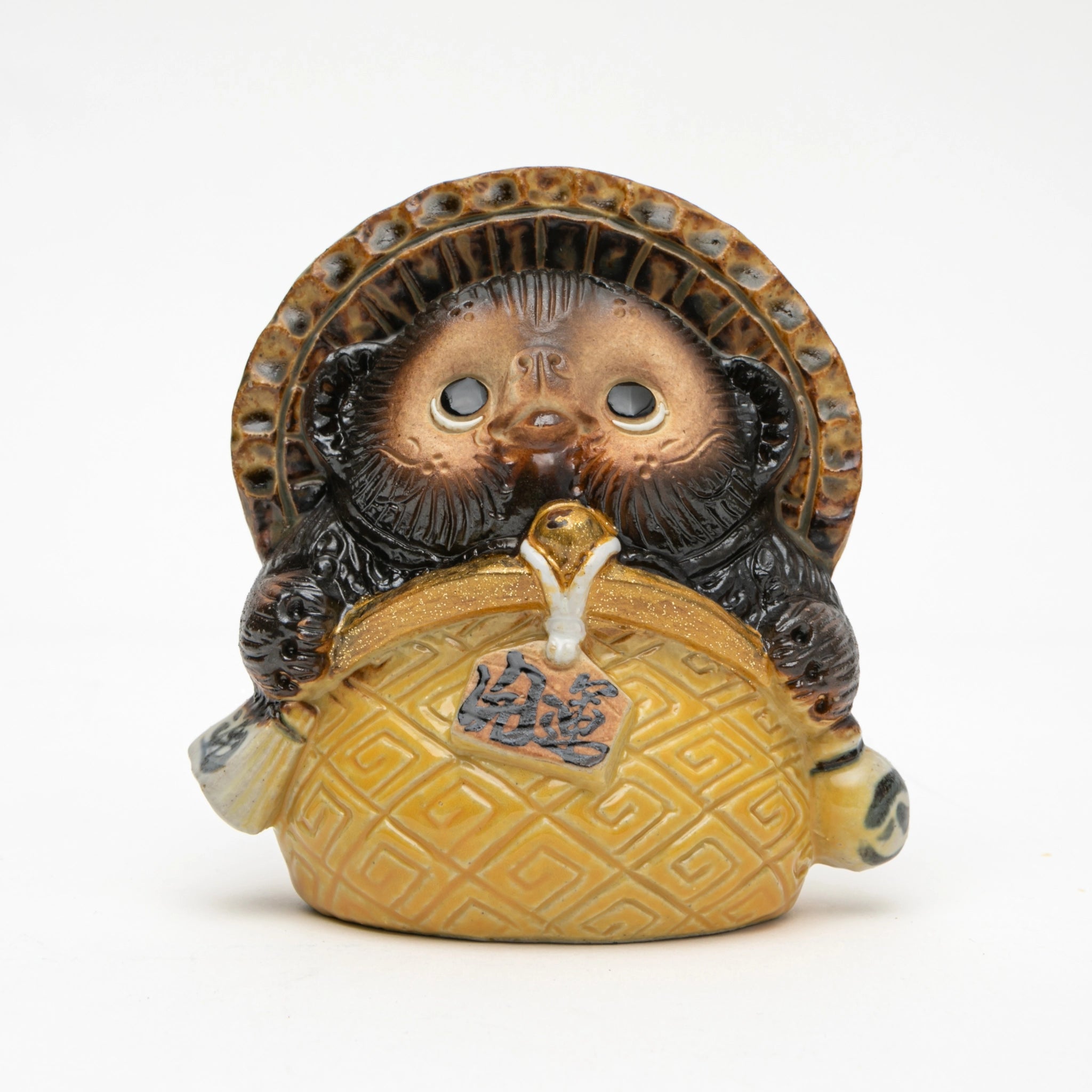 Front view of the Maruichi Shigaraki ware Coin Purse tanuki figurine, showing a compact round form gripping a large golden lattice-patterned coin purse with both paws, straw hat overhead, and wide-eyed forward gaze.