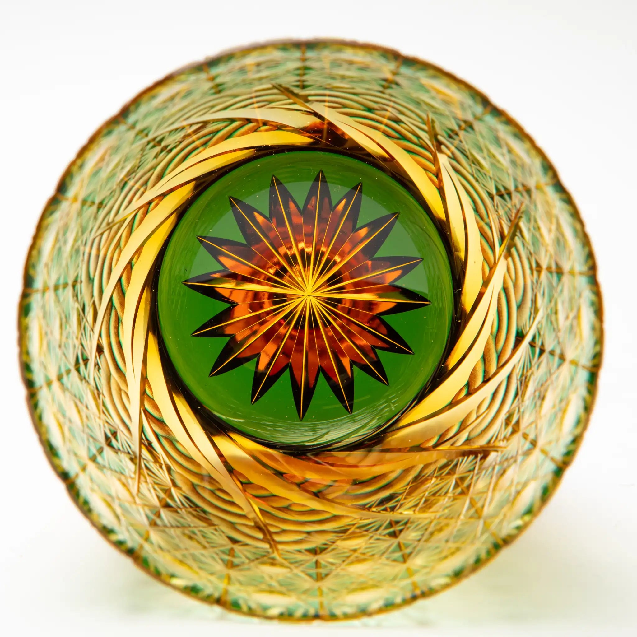 Inside of decorative edo kiriko glass with intricate patterns and a central star design on a white background