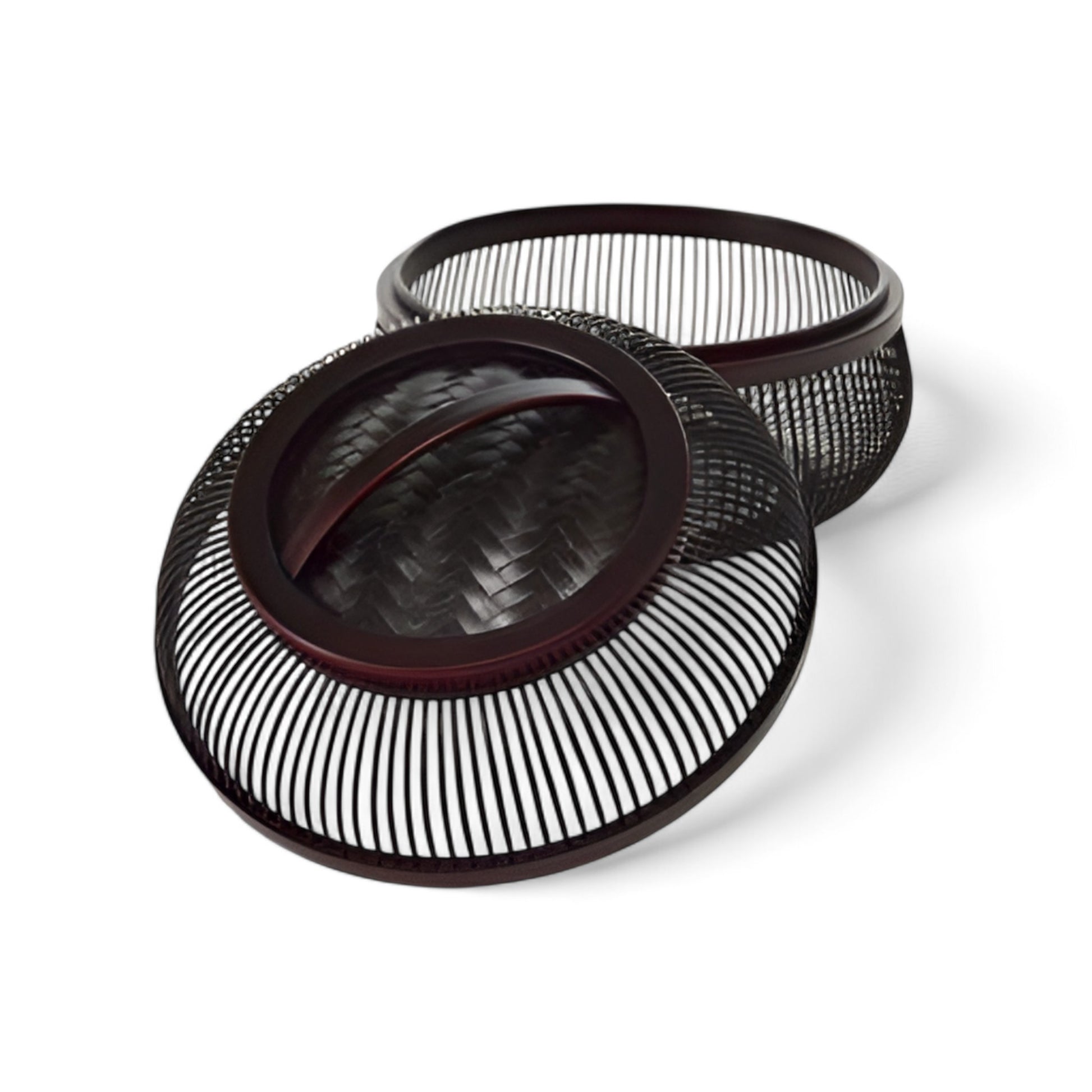 Close-up of two black and brown bamboo baskets with delicate open-weave patterns and removable lids, highlighting their detailed craftsmanship.