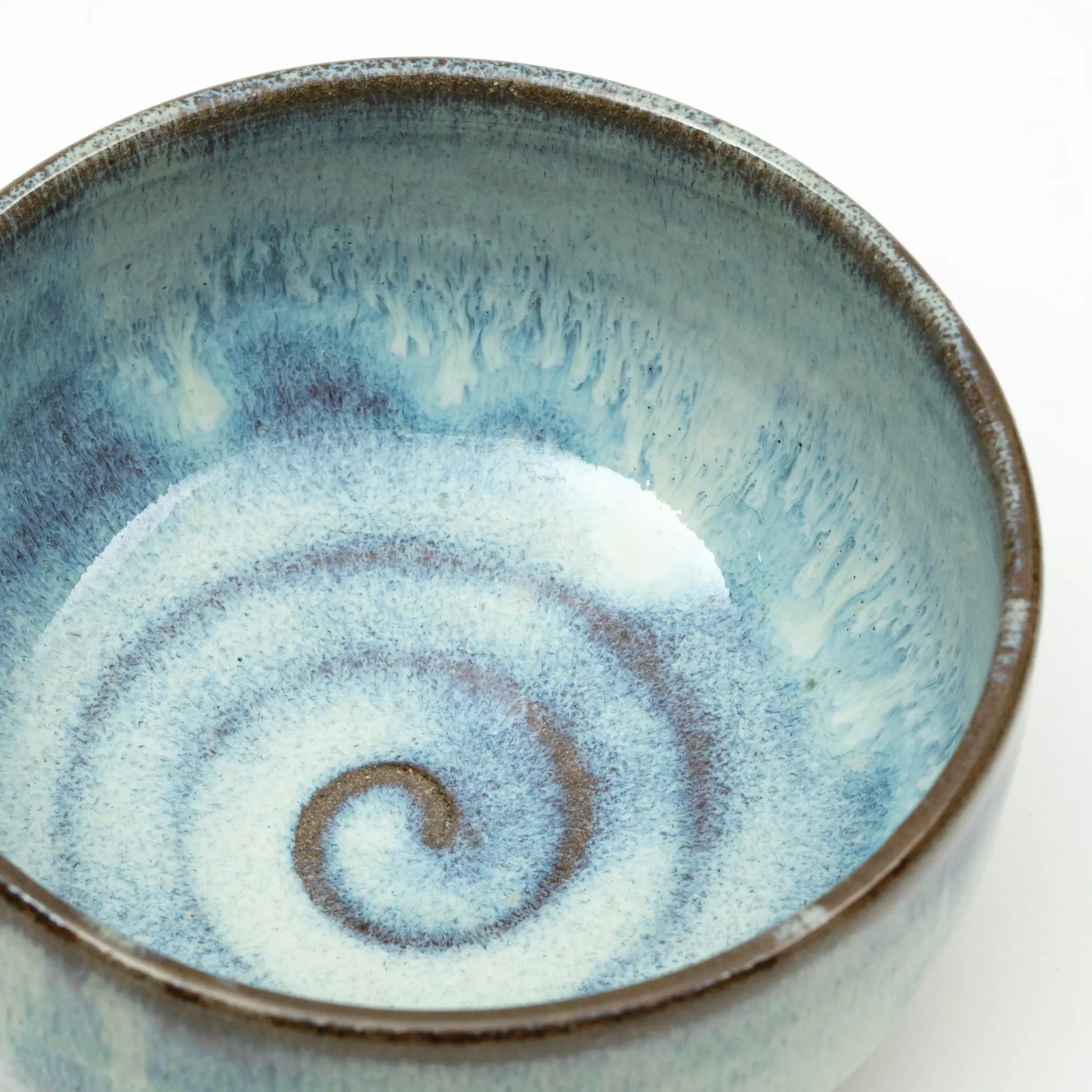 Interior view of the Blue Shodai matcha bowl, featuring a spiral pattern in layered blue and white glaze.