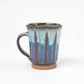 Side view of the Blue Shodai Mug showing its handle and hand-applied gradient glaze details.