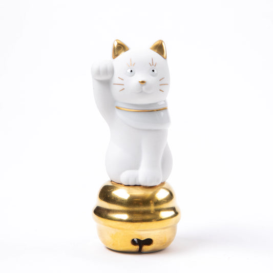 A front-facing view of the Maneki Neko, featuring a friendly expression with gold accents on the ears, whiskers, and bell base.