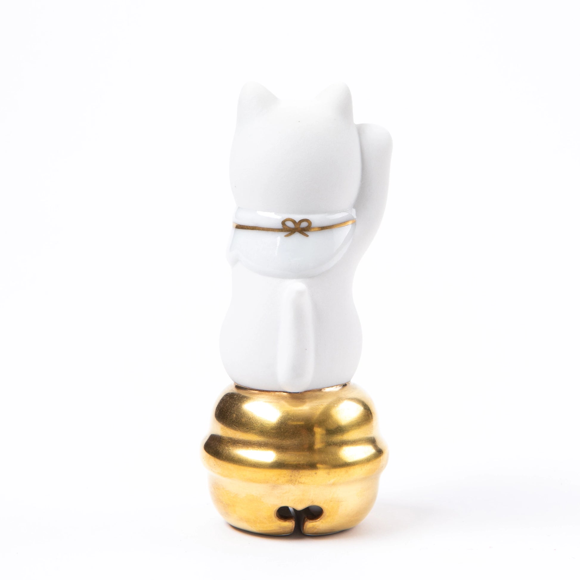 The back view of the Kutani Maneki Neko, highlighting a gold ribbon detail on its white porcelain surface.