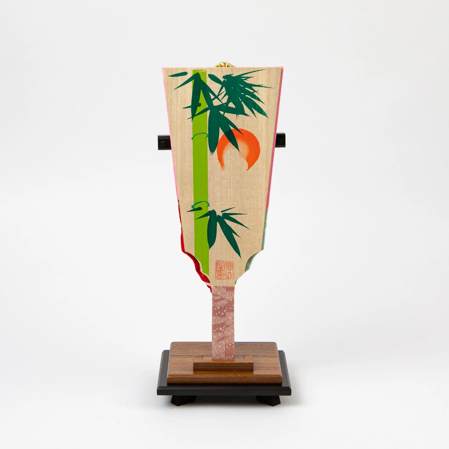 Back of the hagoita paddle with painted bamboo and orange sun design.