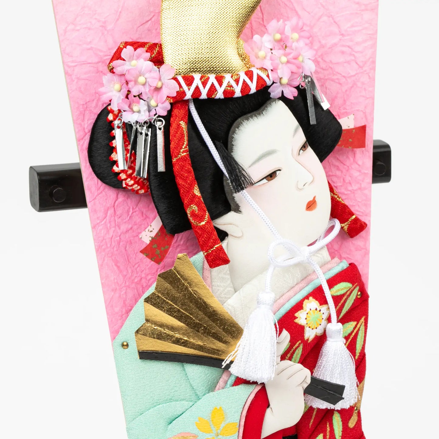 Close-up of Dojoji character with gold hat and ornamental details in kimono and fan.