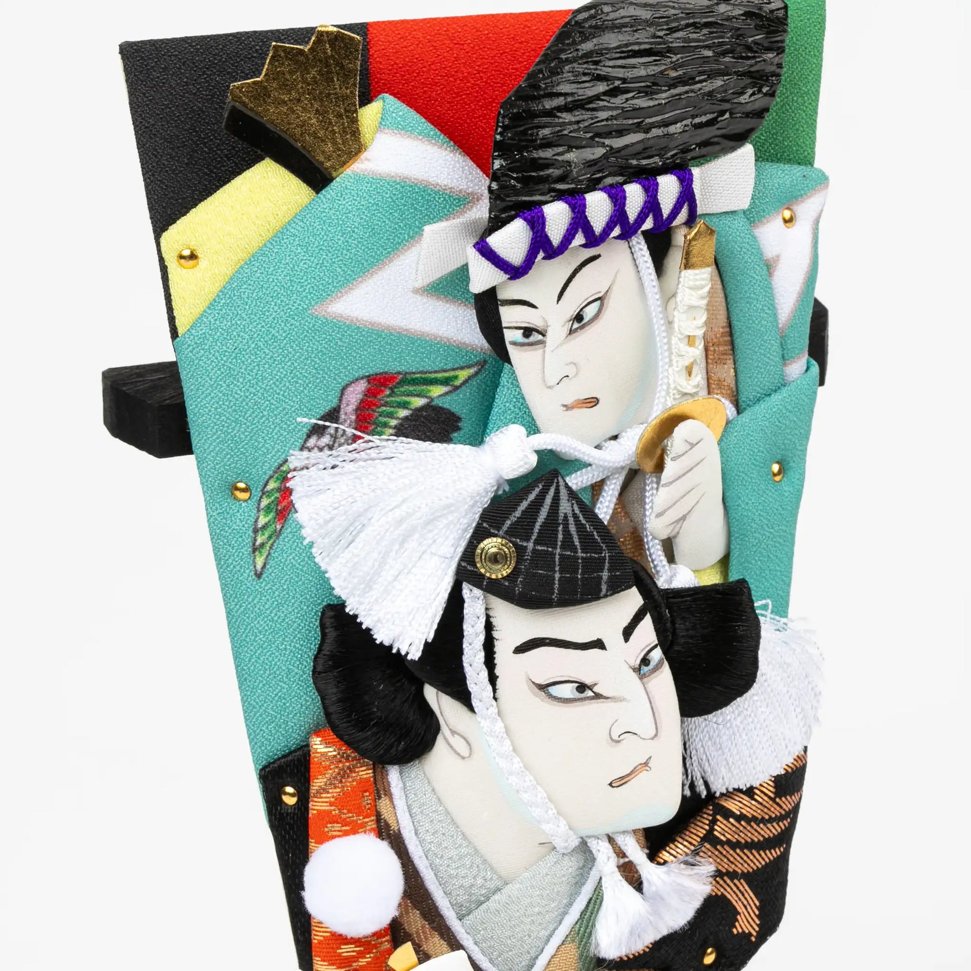 Detailed view of kabuki figures, showcasing intricate embroidery, vibrant patterns, and textured fabric elements.