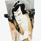 A close-up of the kabuki actor's face and upper body, highlighting the textured fabrics and expressive facial details.