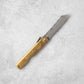 Full view of the Higonokami Damascus knife, featuring a brass handle with engraved Japanese text and a partially extended Damascus blade.