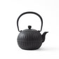 Side view of the Japanese Aster Black Nanbu Cast Iron Teapot, showcasing its traditional design and intricate craftsmanship.