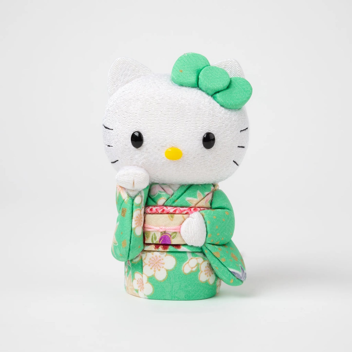 Front view of the Edo Kimekomi Kimono Maneki Hello Kitty Green, featuring Hello Kitty in a traditional Japanese kimono with a green floral pattern and a decorative bow on her head.