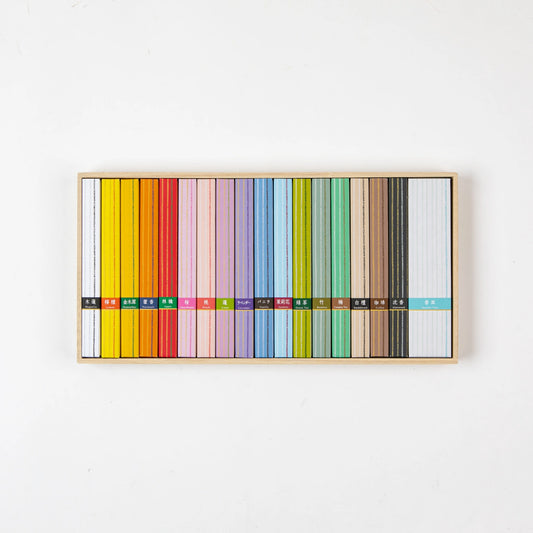 Open box of Kosaido Hyakuraku-kou incense displaying a colorful array of assorted incense sticks neatly arranged by scent.