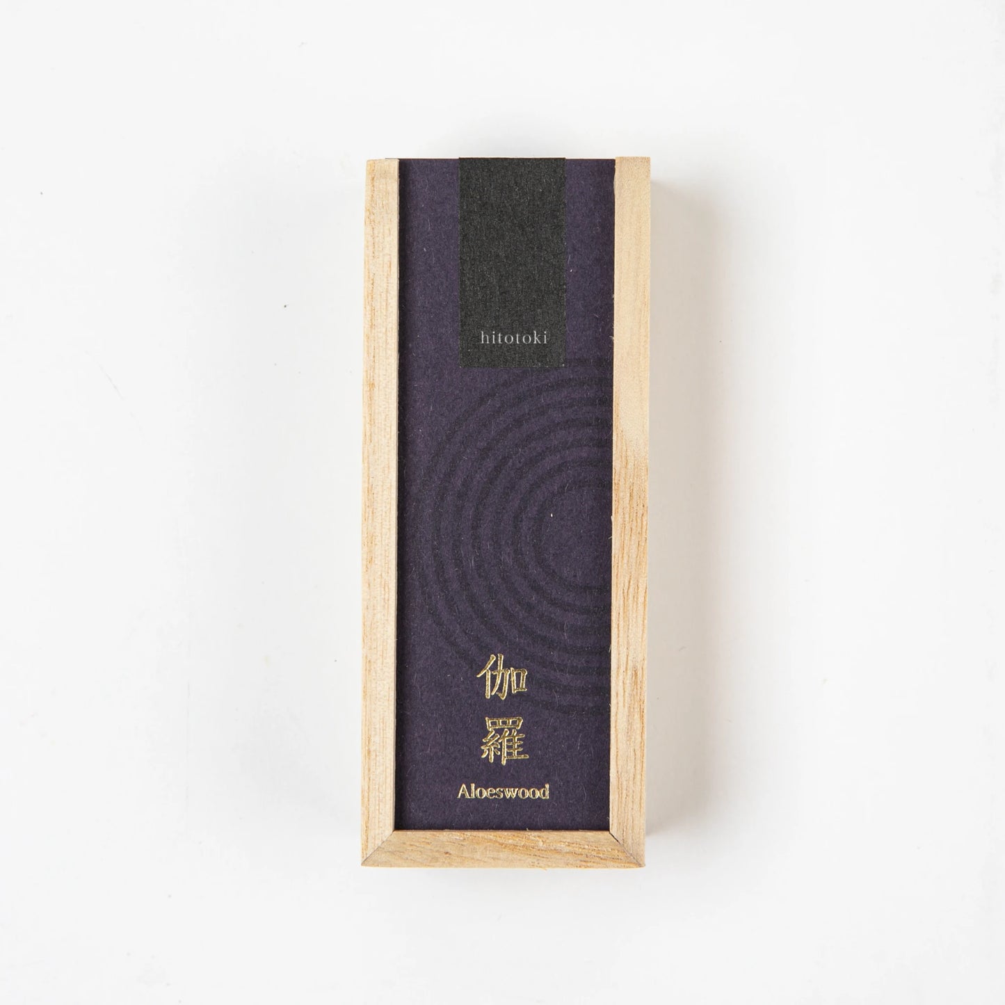 A rectangular wooden box labeled Aloeswood with deep purple and black packaging, photographed from above on a white surface.