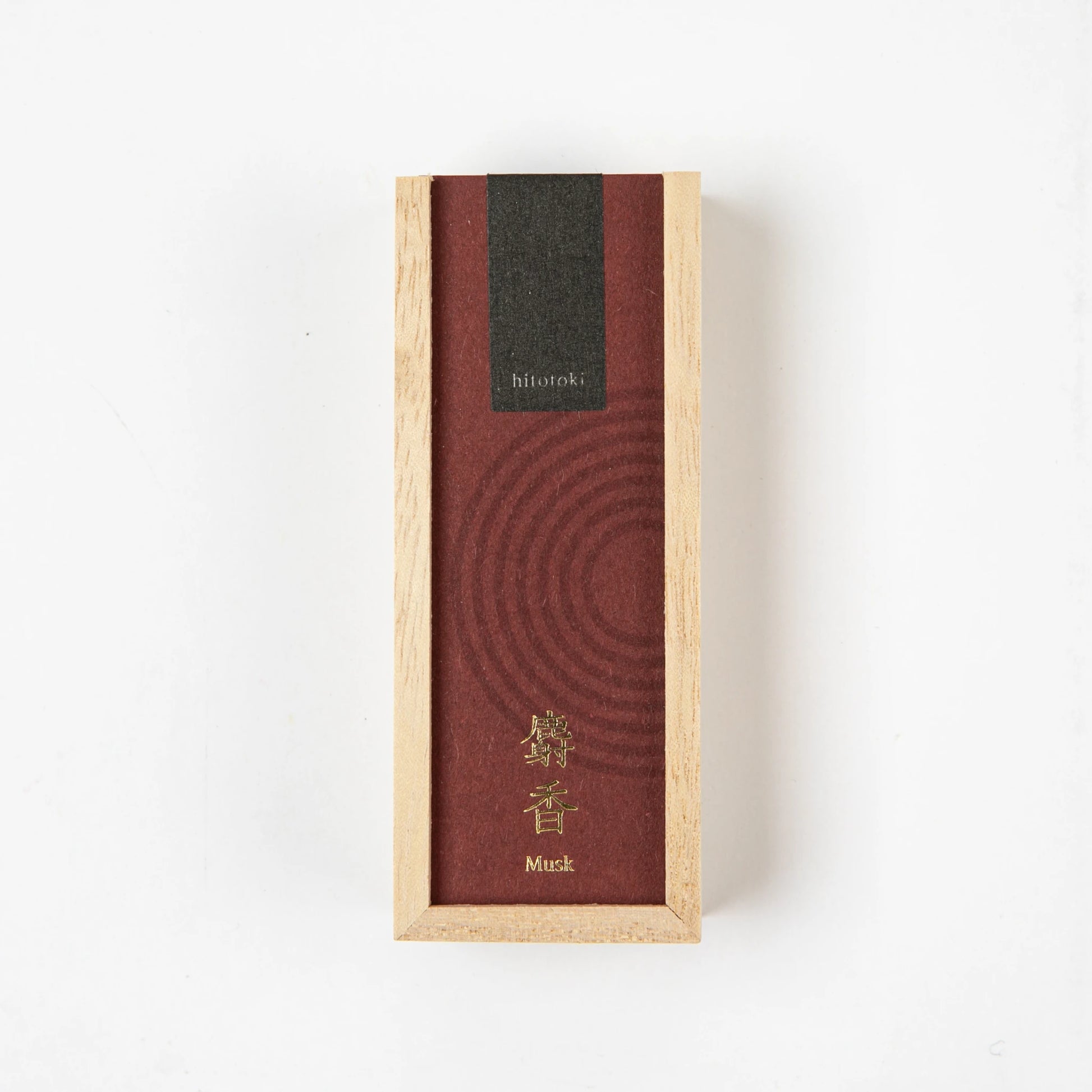 A rectangular wooden box with a deep red label and gold kanji, containing Kosaido hitotoki incense in musk scent, placed on a white background.