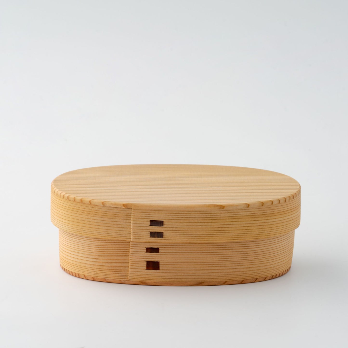A closed Japanese Magewappa bento box with its signature wooden design, featuring a smooth, natural finish.