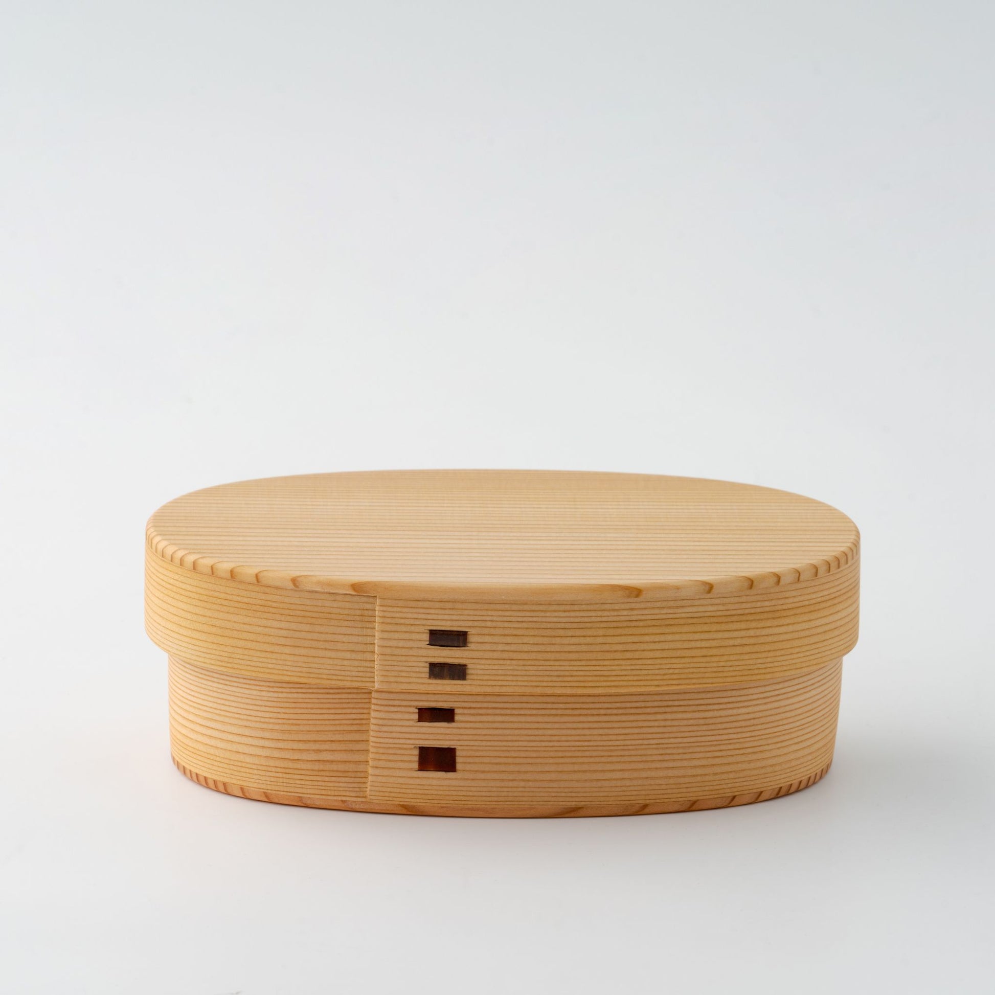 A closed Japanese Magewappa bento box with its signature wooden design, featuring a smooth, natural finish.