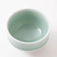 Top view of a Nabeshima Celadon porcelain tea cup showcasing its smooth, glossy green interior.