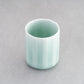 Elegant Nabeshima Celadon Porcelain Teacup with a soft green glaze, displayed on a gray background.