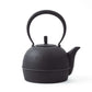 Side view of the Classic Arare black Nambu cast iron teapot, showcasing the spout and unique textured pattern.