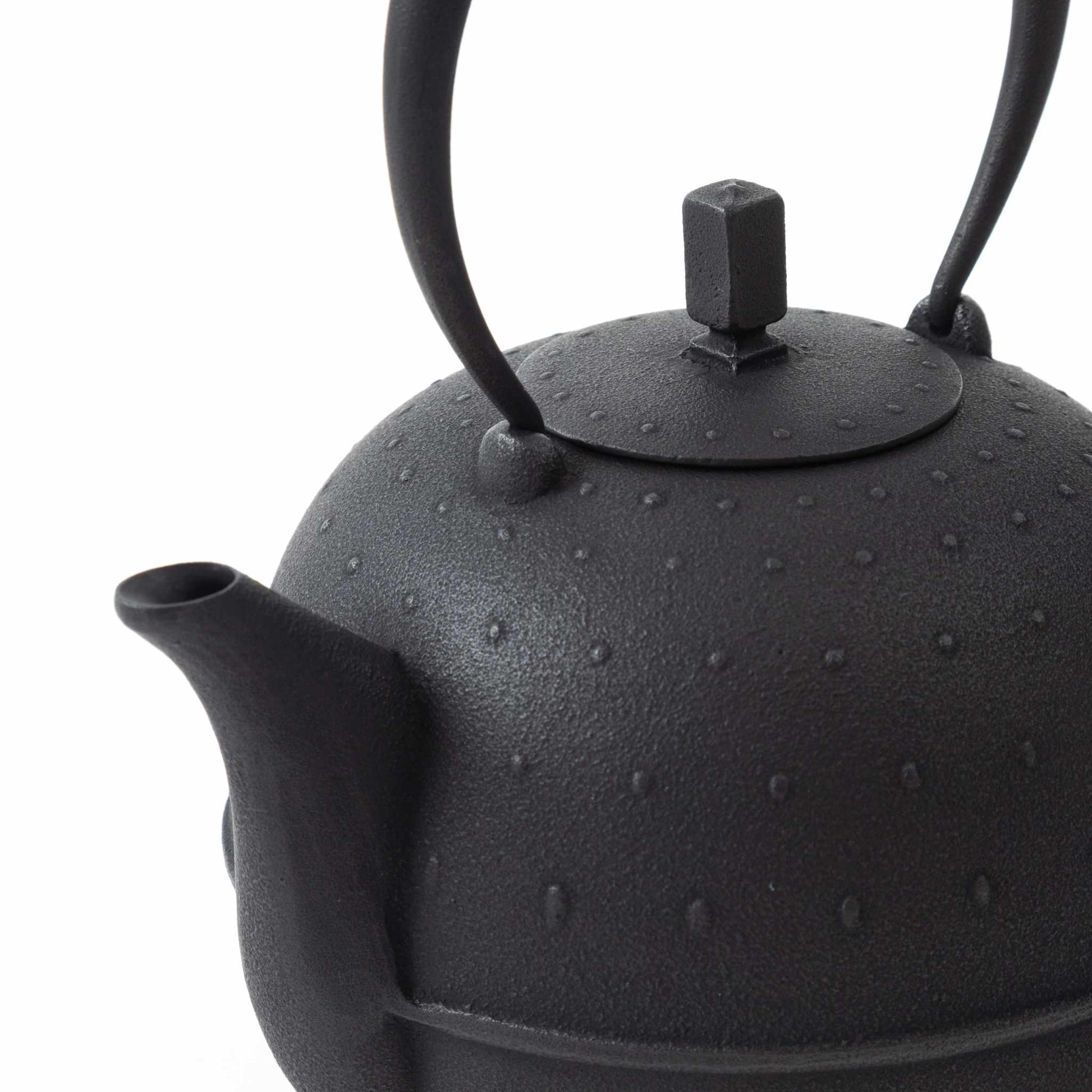 Close-up of the Classic Arare black Nambu cast iron teapot, highlighting the lid and detailed craftsmanship.