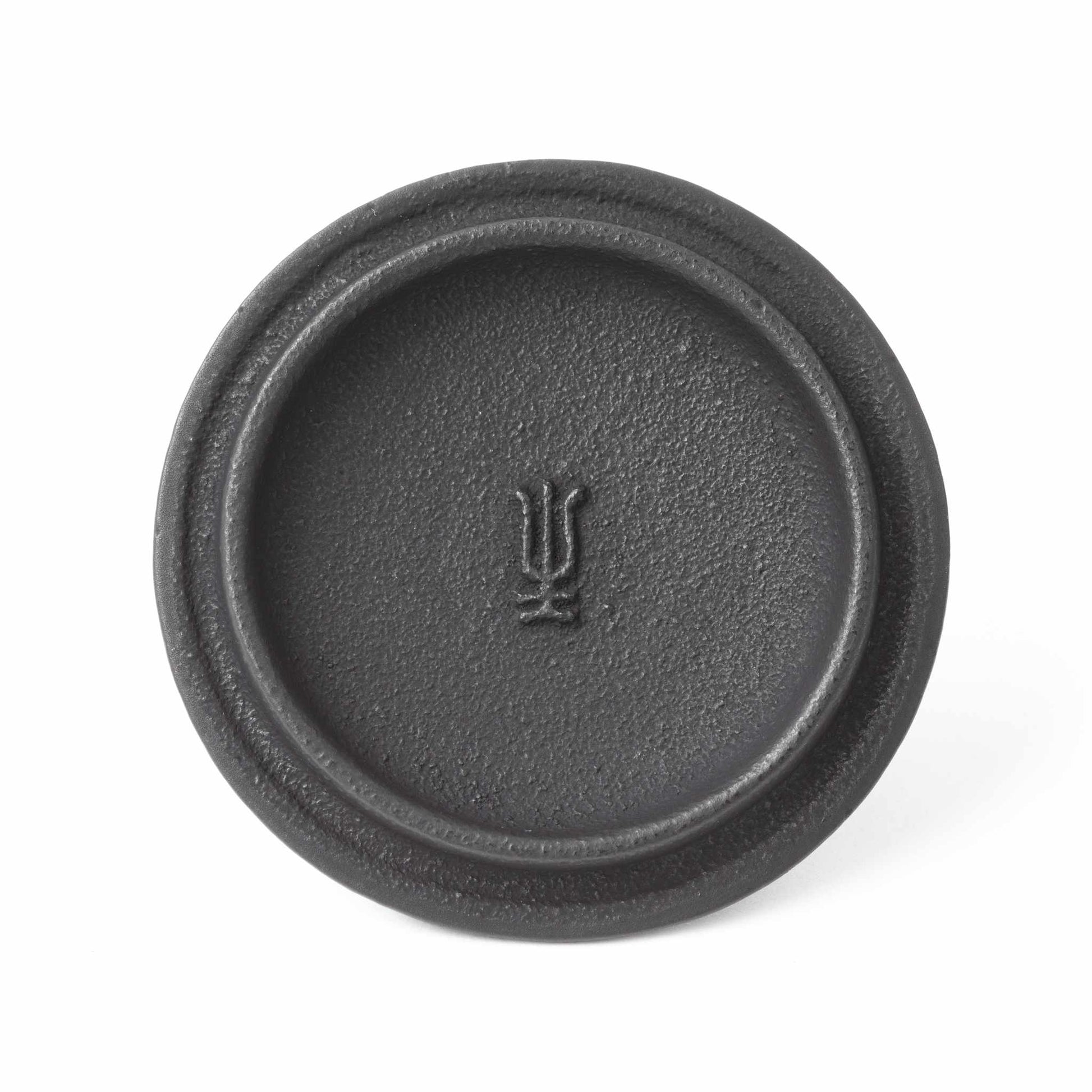 Close-up of the lid from the Classic Arare black Nambu cast iron teapot, featuring a traditional Japanese symbol.