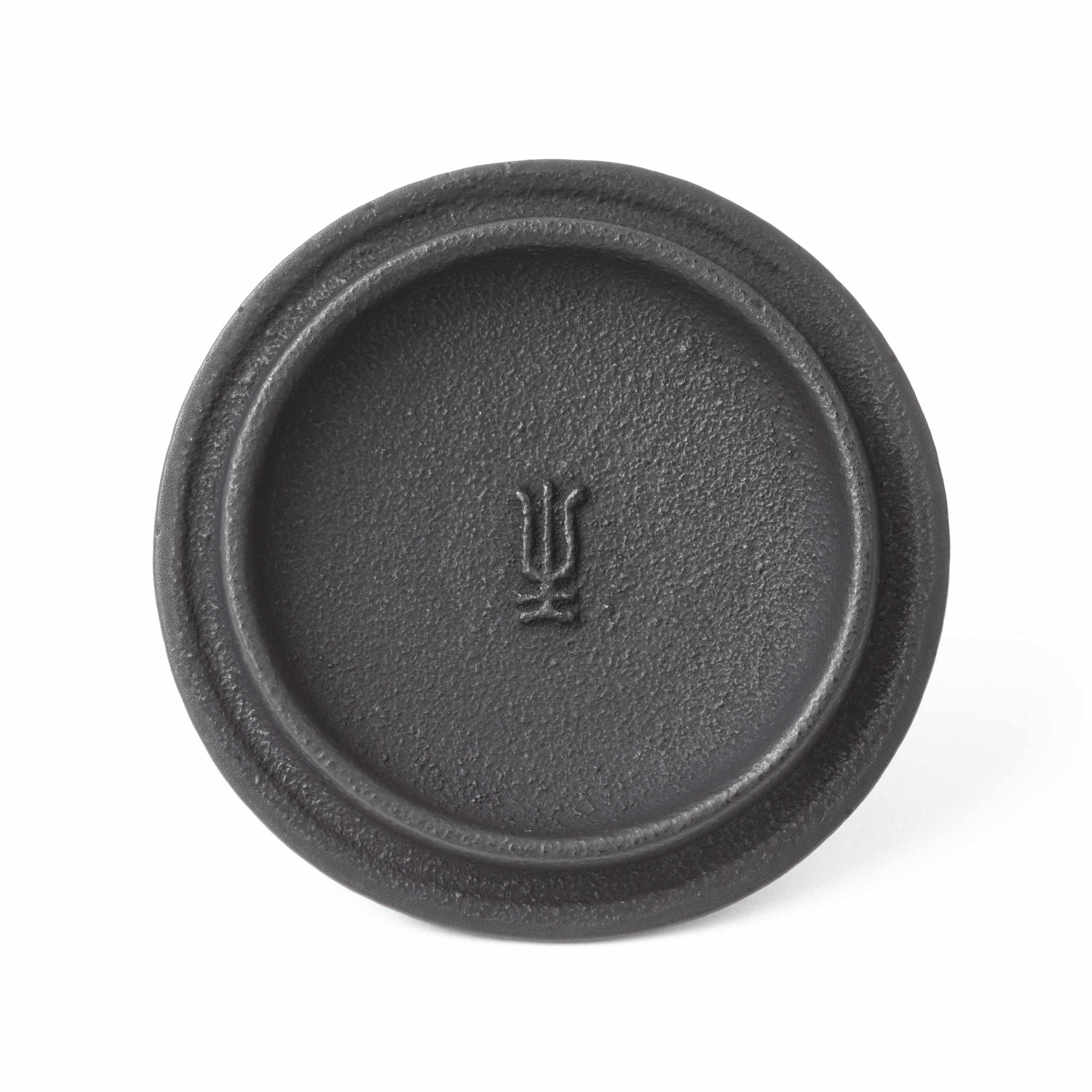 Close-up of the lid from the Classic Arare black Nambu cast iron teapot, featuring a traditional Japanese symbol.