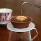 Pouring the hot water to drip the coffee with Hasami ware ceramic coffee filter in brown