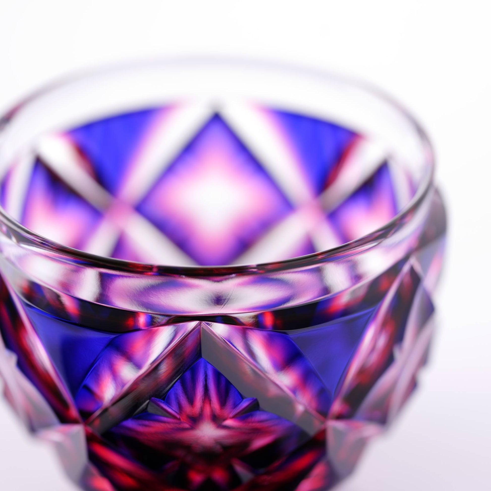 Close-up of intricate starburst design in a Satsuma Kiriko Lapis Red sake cup.
