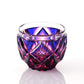 A detailed shot of a Satsuma Kiriko Lapis Red sake cup with diamond-cut facets.