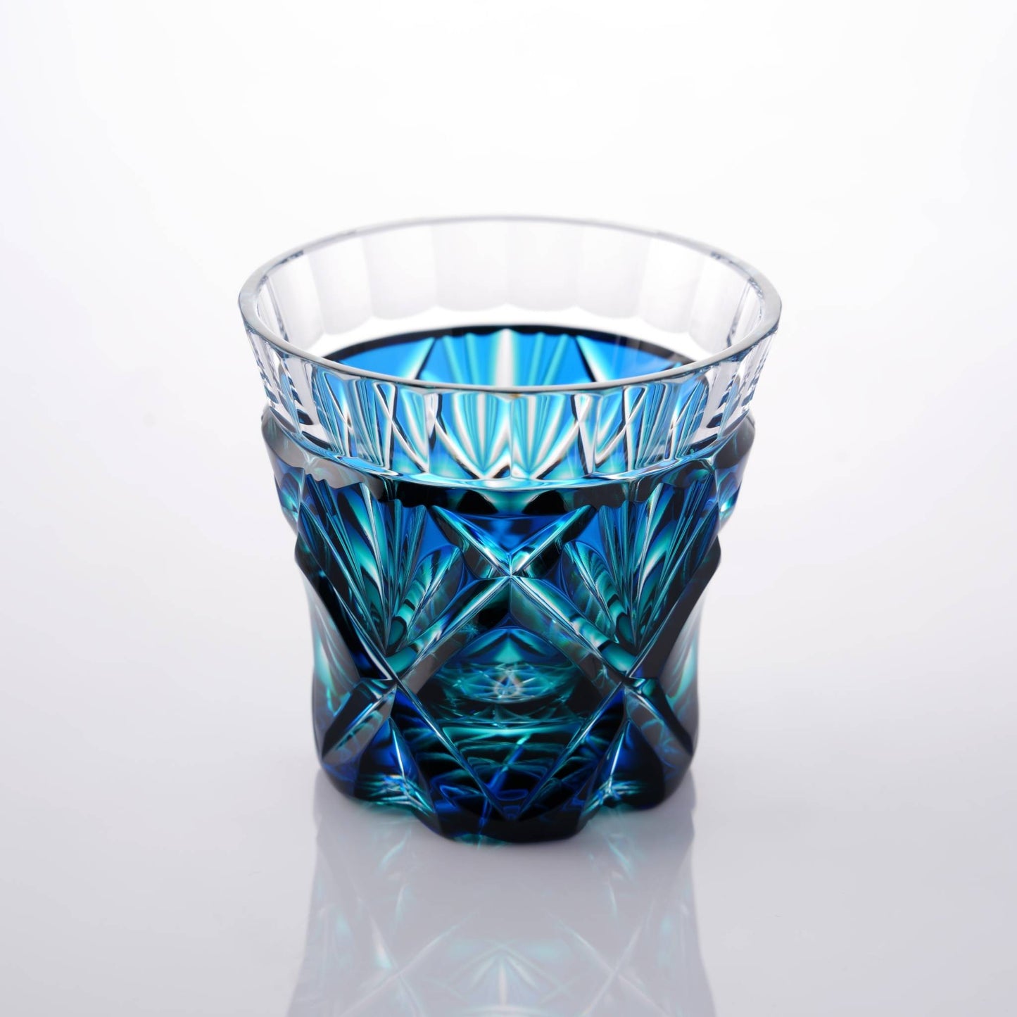 Satsuma Kiriko two-tone sake cup, Lapis Green, with clear and green glass highlighting the artisan craftsmanship.