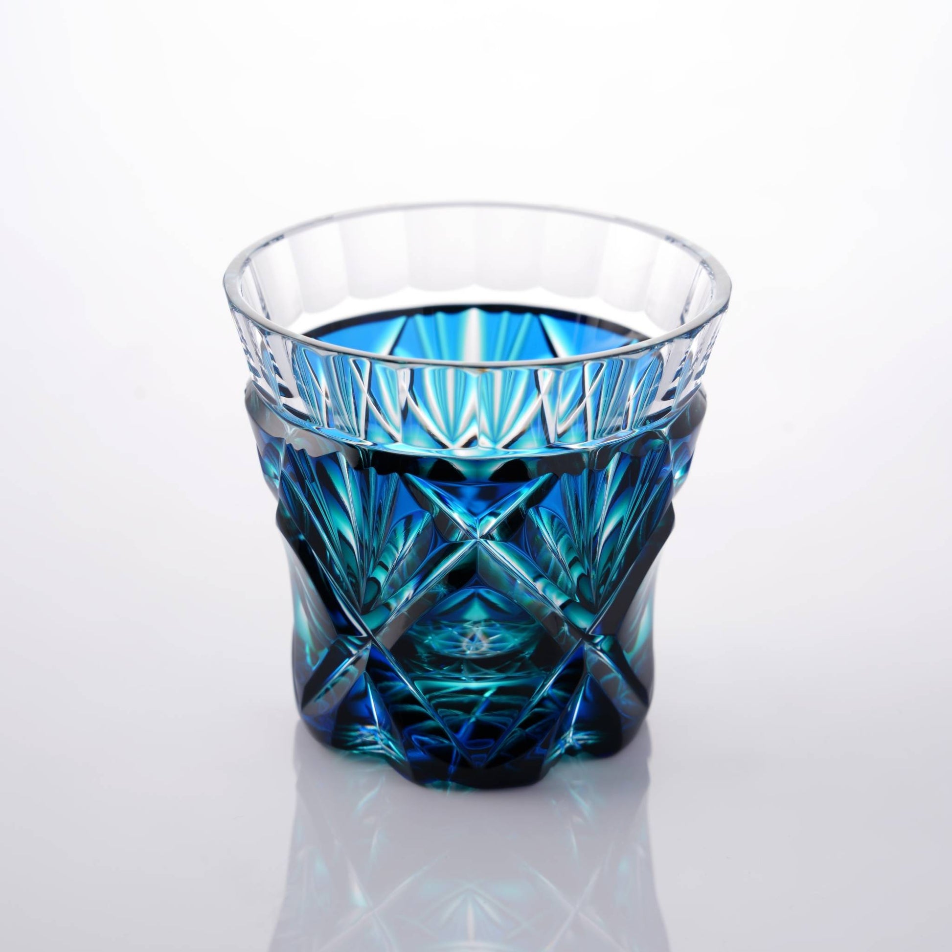 Satsuma Kiriko two-tone sake cup, Lapis Green, with clear and green glass highlighting the artisan craftsmanship.
