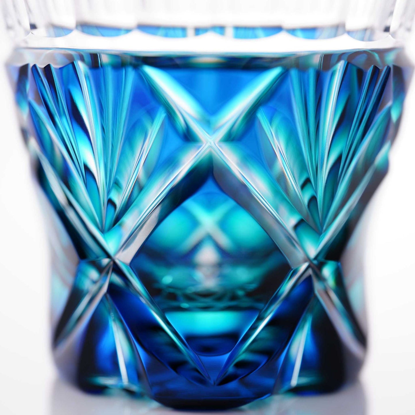 Close-up of the geometric and floral design on the Satsuma Kiriko two-tone sake cup, Lapis Green.