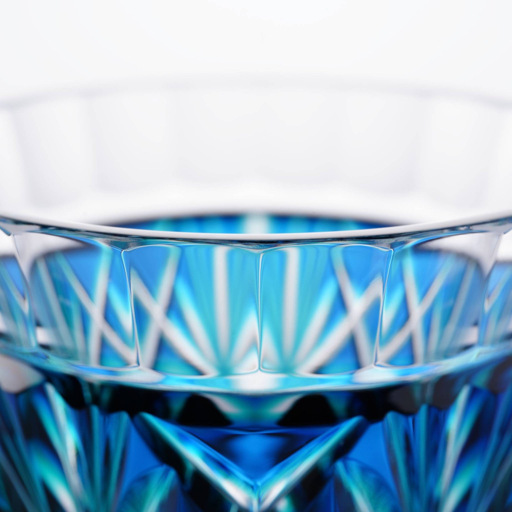 Close-up of the finely crafted rim of the Satsuma Kiriko two-tone sake cup in Lapis Green.