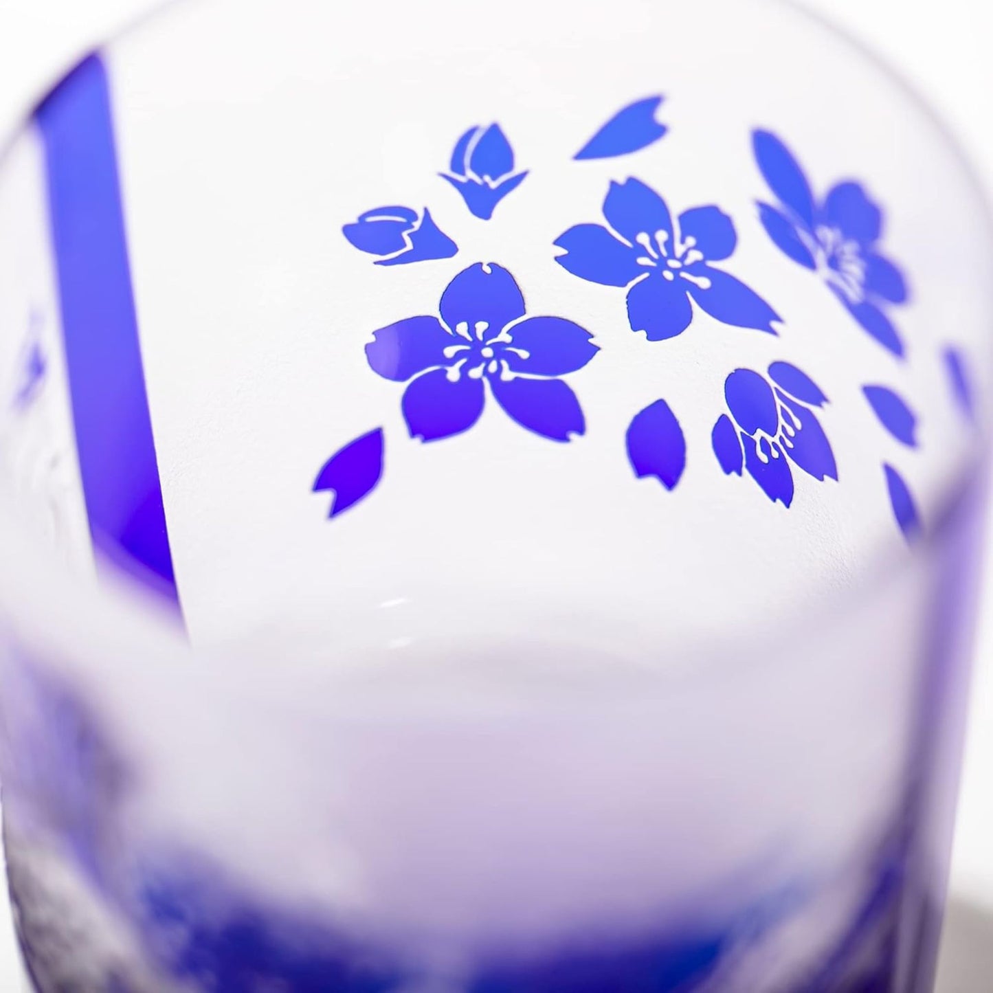 Top view of the whiskey glass showcasing delicate sakura (cherry blossom) flowers in blue on the inner rim of the glass.