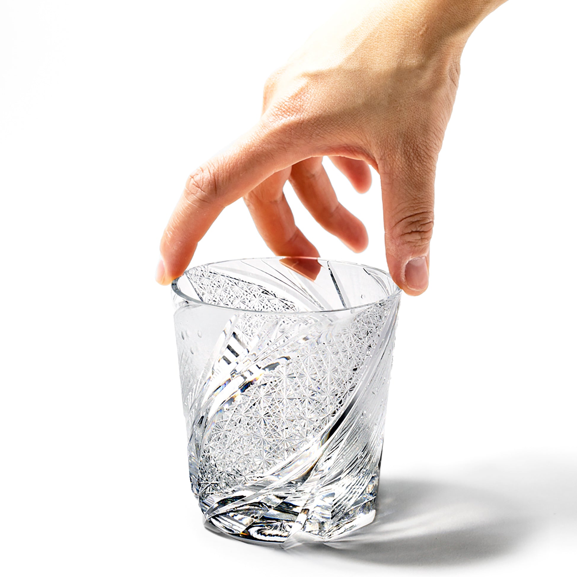 Hand holding Edo Kiriko Meteor Whiskey Glass from Tableau