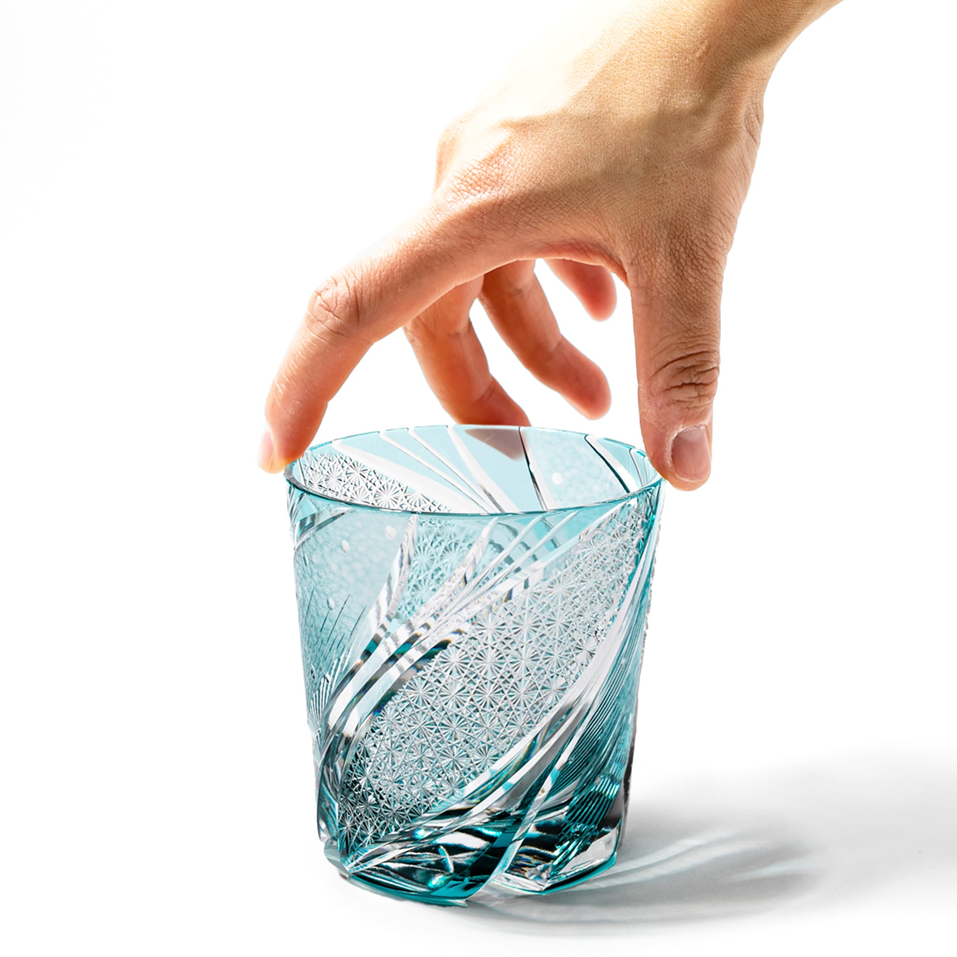 Hand hodling green Edo Kiriko Meteor Whiskey Glass from Tableau