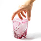 Hand holding red Edo Kiriko Meteor Whiskey Glass from Tableau