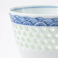Close-up of the dotted celadon texture and wave motif on the Tanshingama Crest Cup.