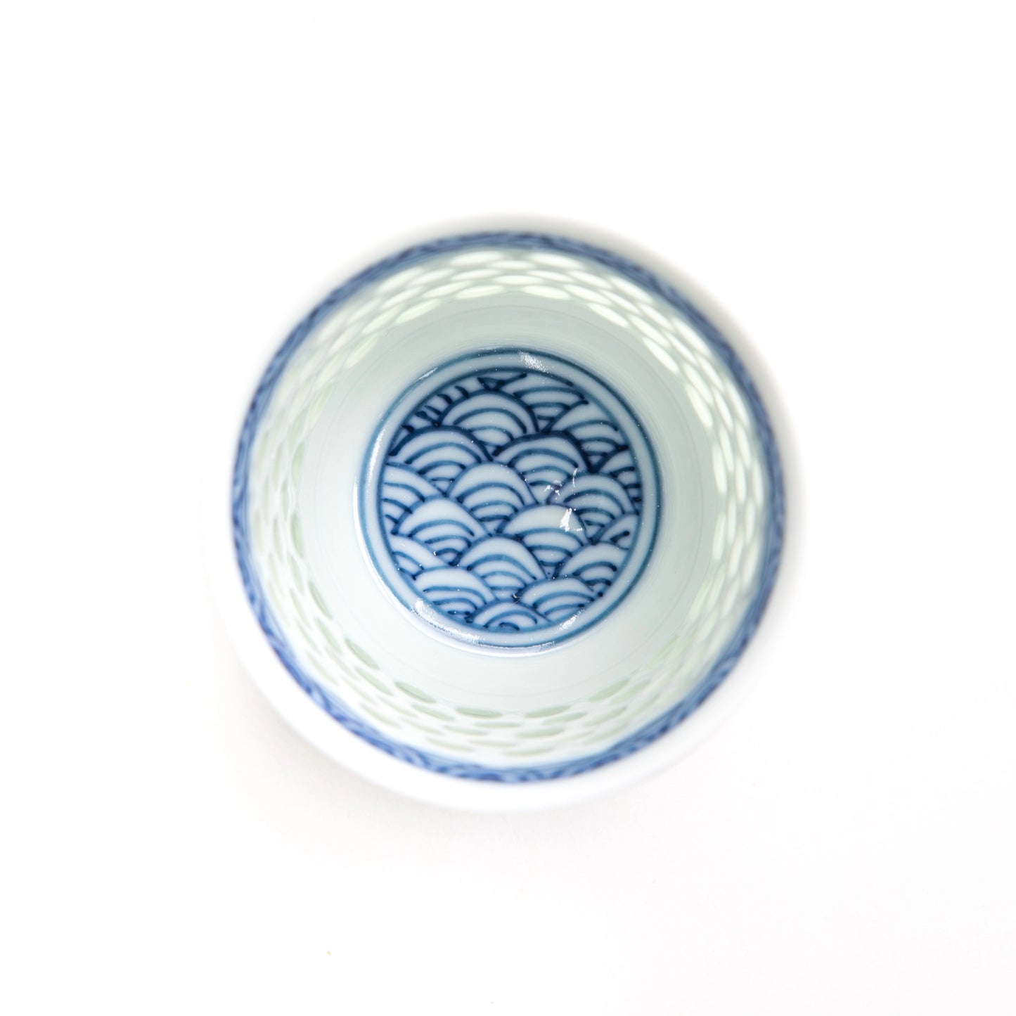 Top-down view of the Tanshingama Sake Cup with celadon dots and a seigaiha wave design at the base.