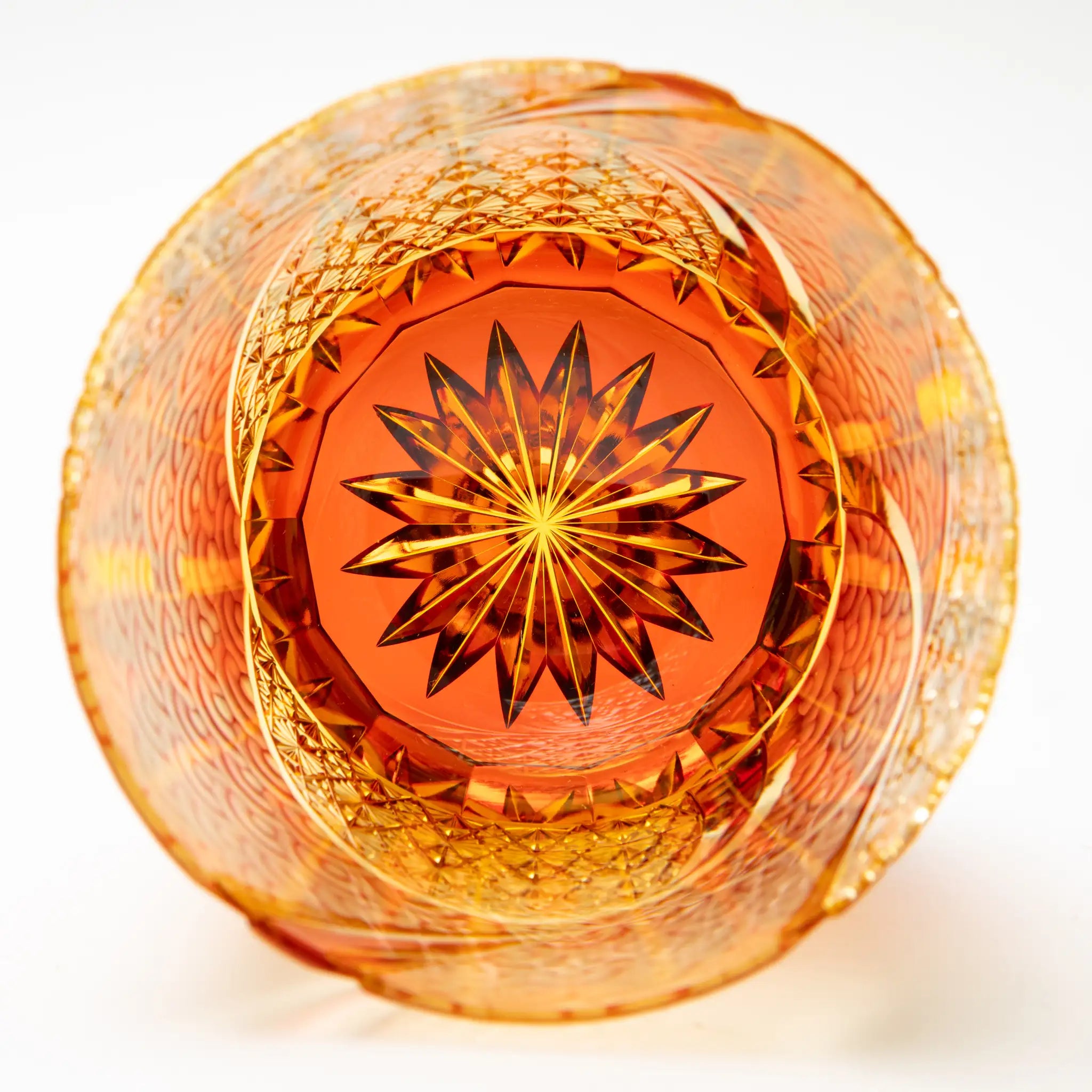 Decorative edo kiriko glass inside with starburst pattern on a white background