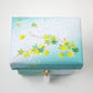 Top view of the Kaga Yuzen Maple Leaf Accessory Box, featuring an elegant pattern of maple leaves in green and yellow shades on a light mint green fabric background.